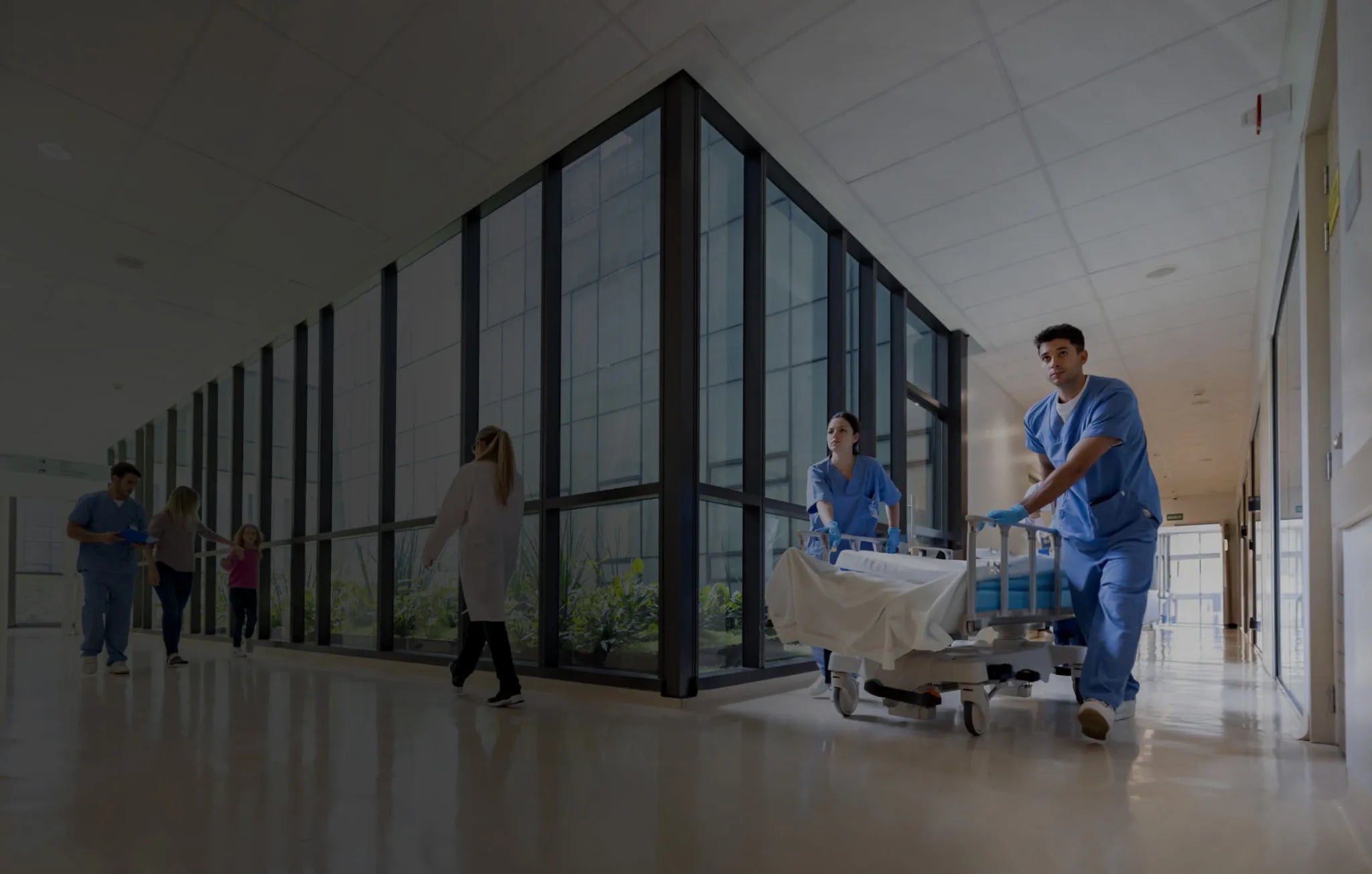 Crowded hospital corridor with healthcare workers and visitors, highlighting the risk of airborne illness transmission in high-traffic healthcare environments.