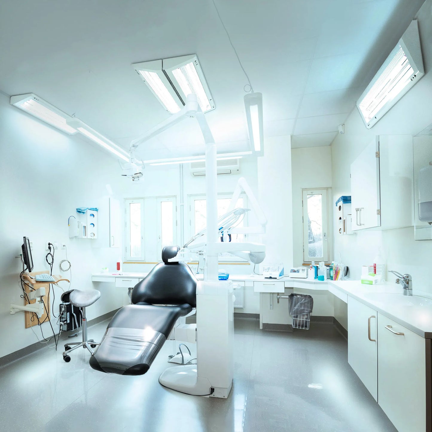 Ceiling and wall mounted ASEPT 1X MAX UV sanitizer installed in a modern dental office.